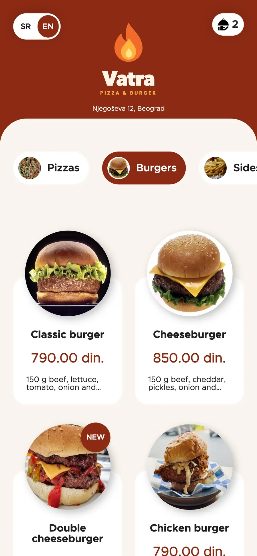 Orbi online ordering on a phone, in English: the burger menu with photos and prices, two items in the cart.
